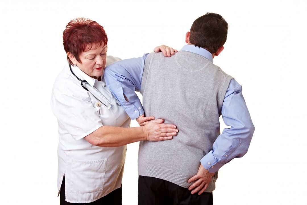 A doctor examines a patient with back pain